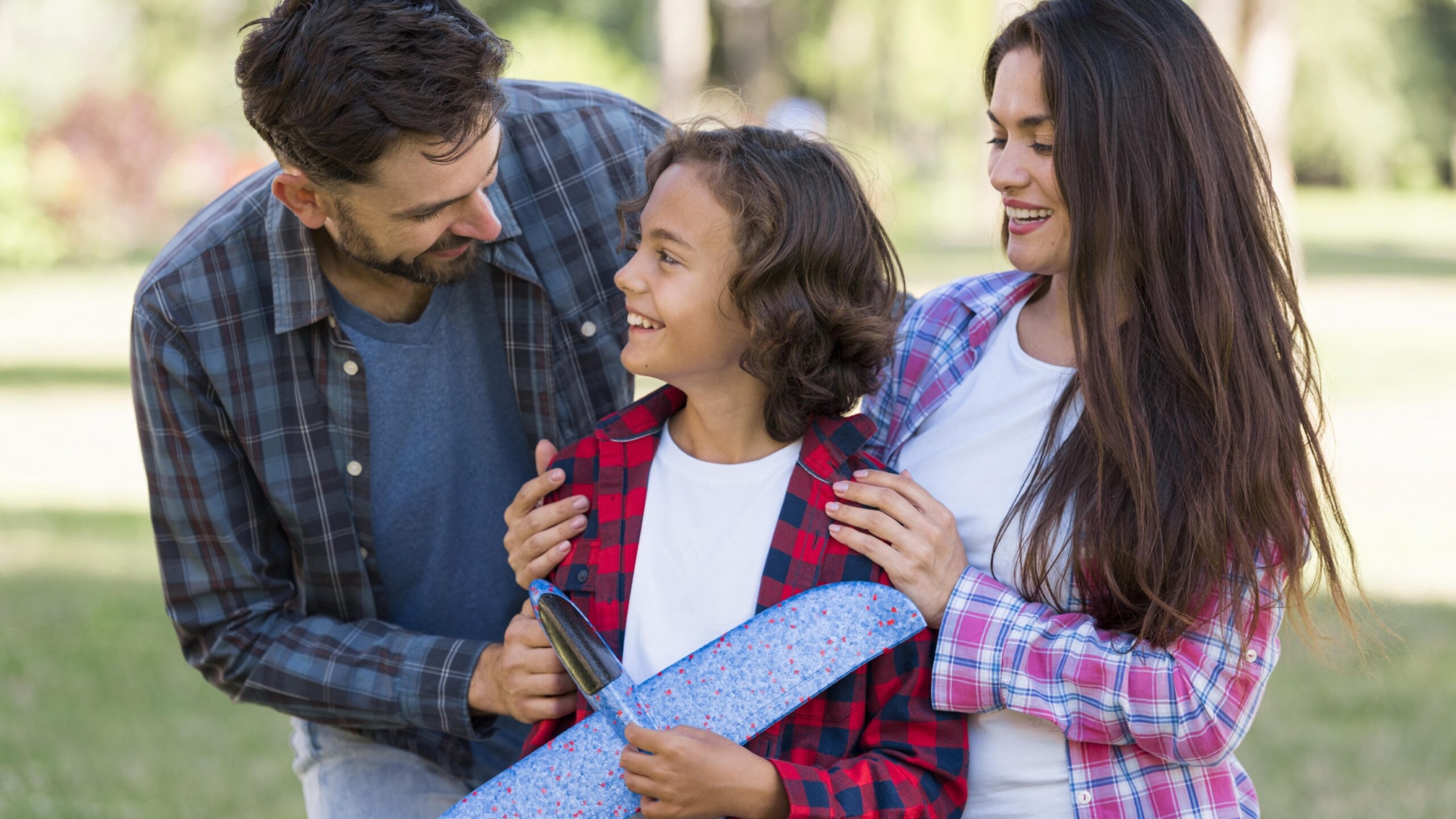 boy-with-airplane-parents-park-together